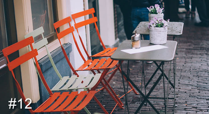 Photo of four chairs outside a cafe