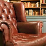 Photo of an old leather armchair in front of a bookcase