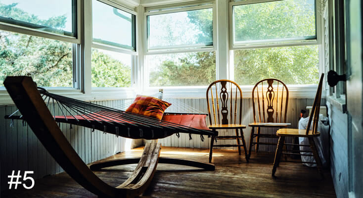 Photo of a hammock indoors with a couple of kitchen chairs