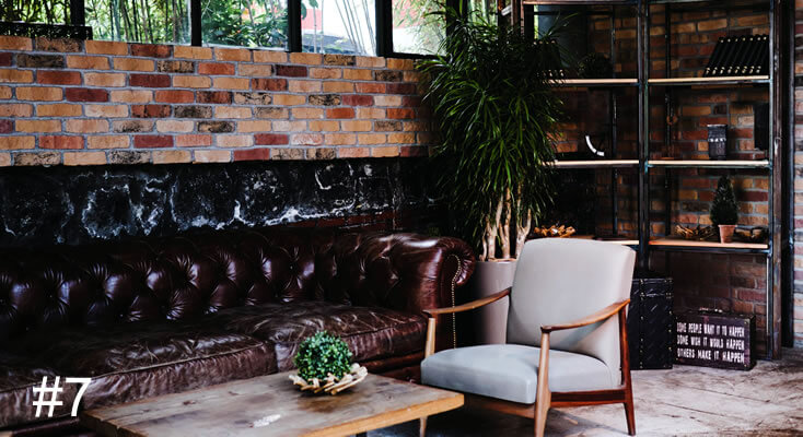 Photo of an armchair and a leather lounge in a cafe environment
