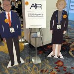 Photo of two cardboard cutout people advertising 'A Holistic Approach to Institutional Research'
