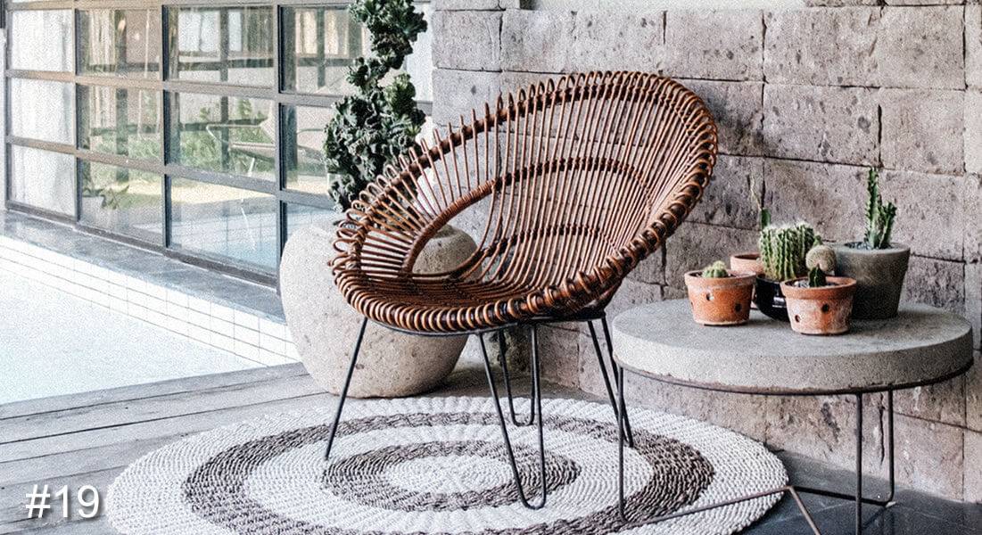Photo of a circular wicker style chair on a circular mat