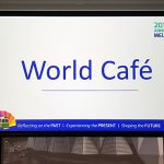 Photo of an overhead projector screen with the words 'World Cafe' on it