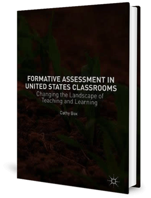 Cover of a book with new green plants growing from soil