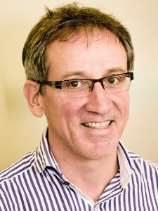 Photo of Michael Rothery wearing glasses and a striped shirt.