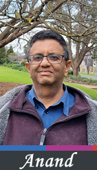 Photo of Anand Kulkarni in gardens with trees behind him.