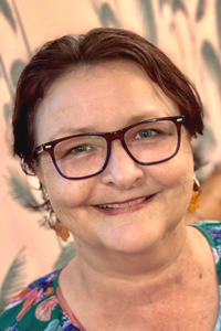 Photo of Sharon Liddell wearing glasses and smiling.